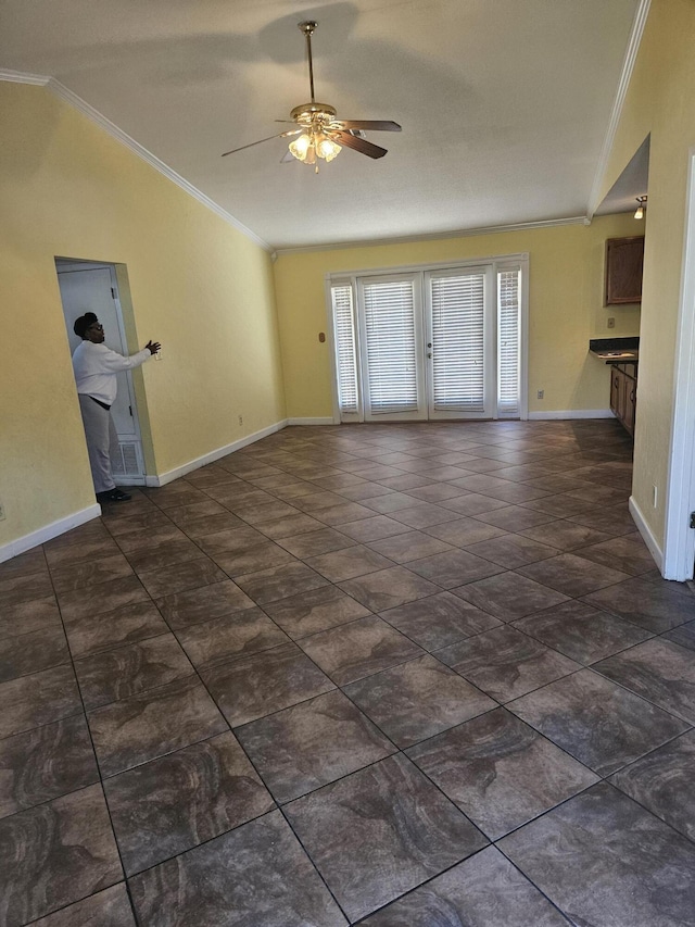 unfurnished living room with ceiling fan, ornamental molding, and vaulted ceiling