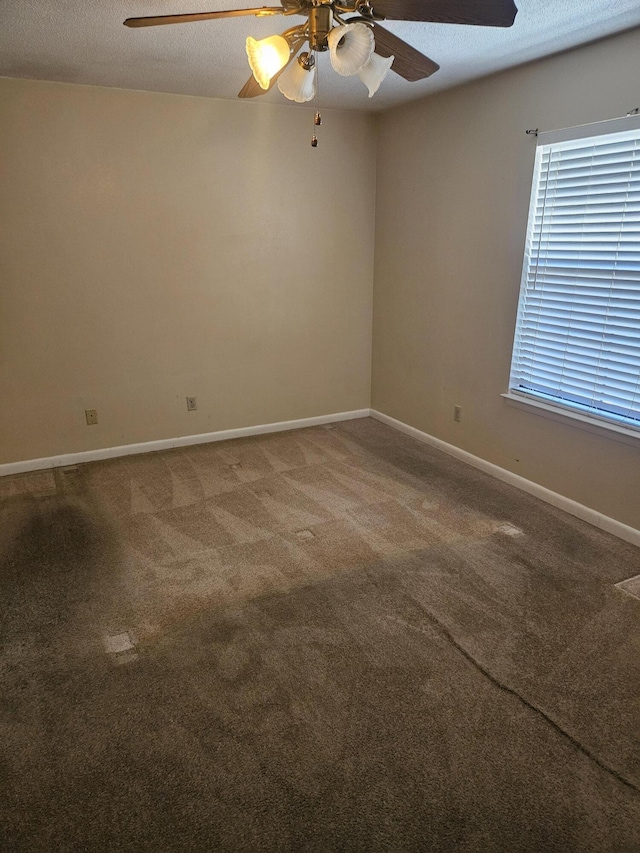 carpeted empty room with a textured ceiling