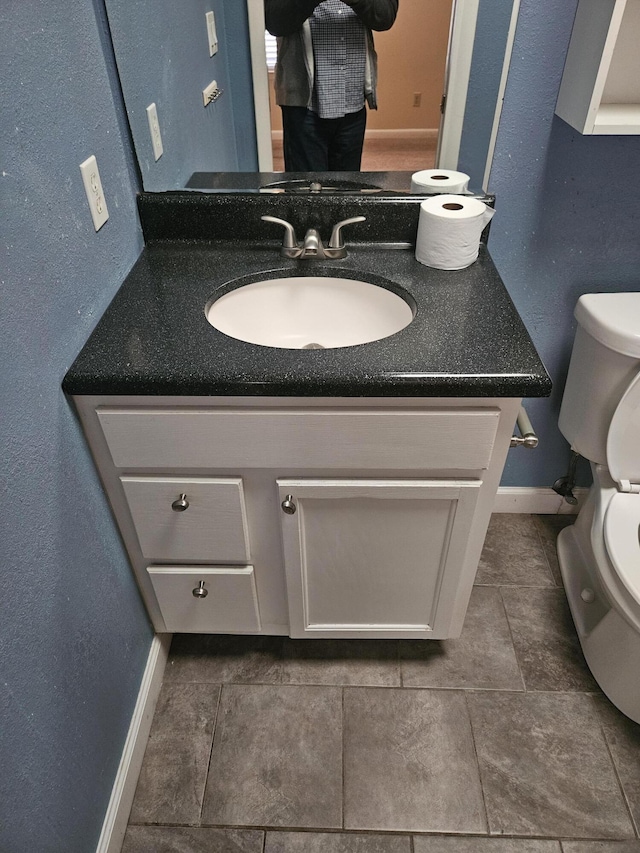 bathroom with tile patterned floors, vanity, and toilet