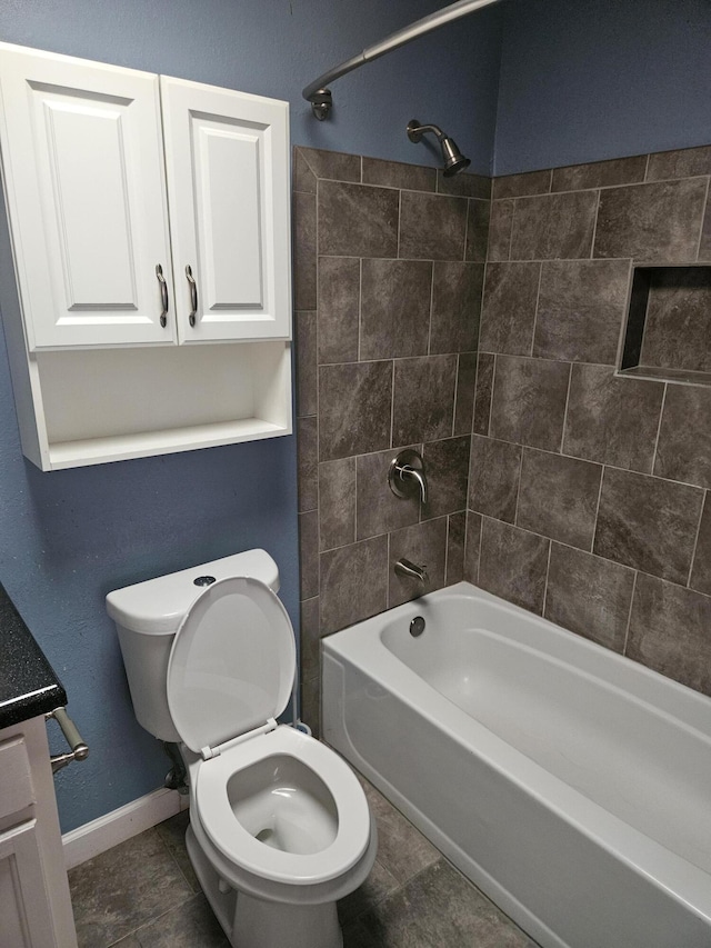 full bathroom featuring tile patterned floors, vanity, toilet, and tiled shower / bath