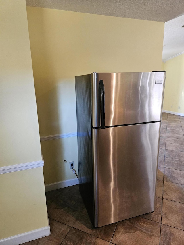 kitchen with tile patterned floors and stainless steel fridge