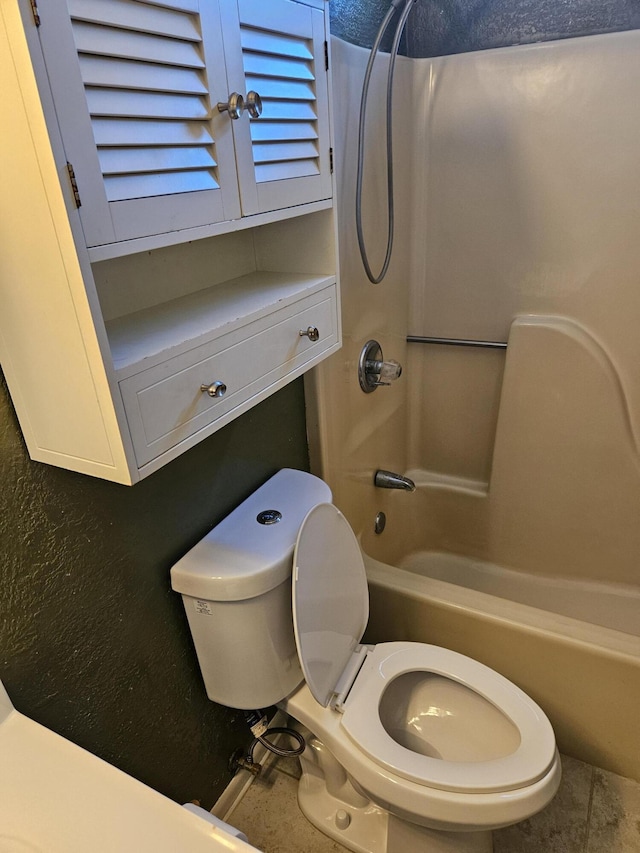 bathroom featuring bathing tub / shower combination and toilet