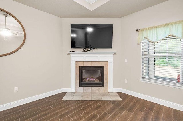 unfurnished living room with a tiled fireplace