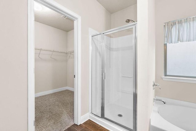 bathroom featuring shower with separate bathtub