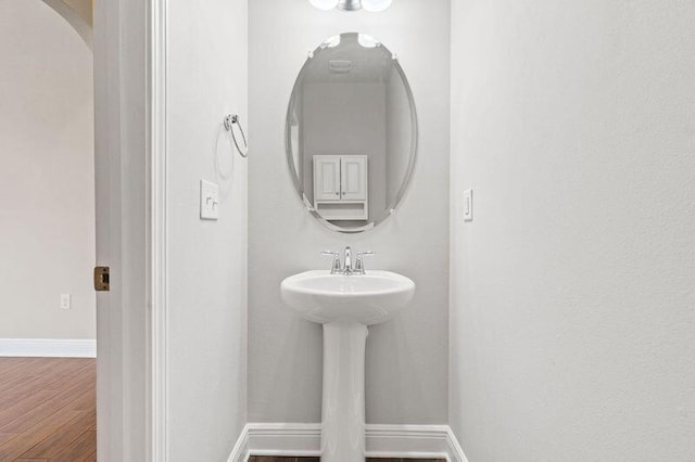 bathroom with hardwood / wood-style flooring and sink