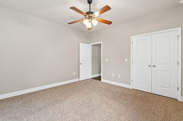 unfurnished bedroom featuring carpet flooring, ceiling fan, and a closet