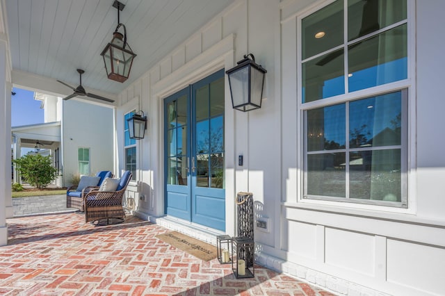 doorway to property with french doors, a porch, and ceiling fan