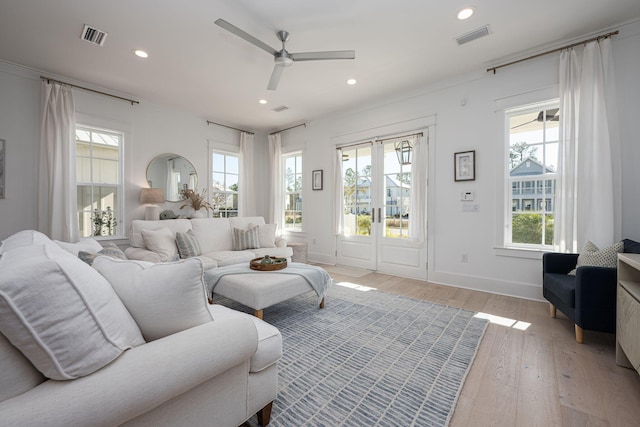 living room featuring ceiling fan, french doors, and light hardwood / wood-style flooring