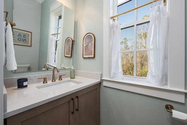 bathroom featuring vanity and toilet