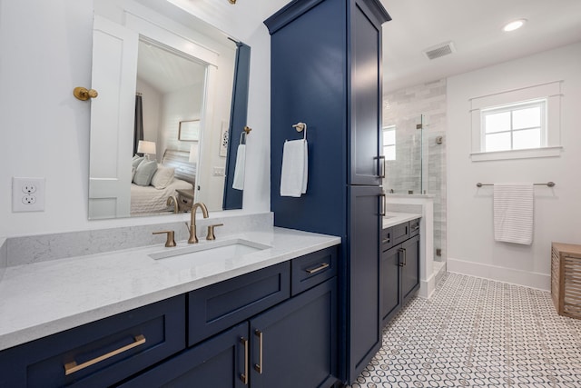 bathroom with vanity and a shower with shower door