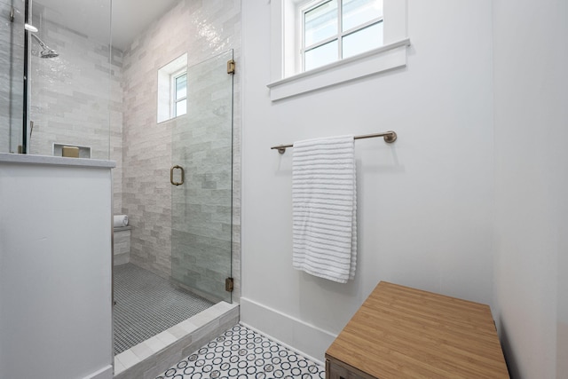 bathroom featuring tile patterned flooring and an enclosed shower