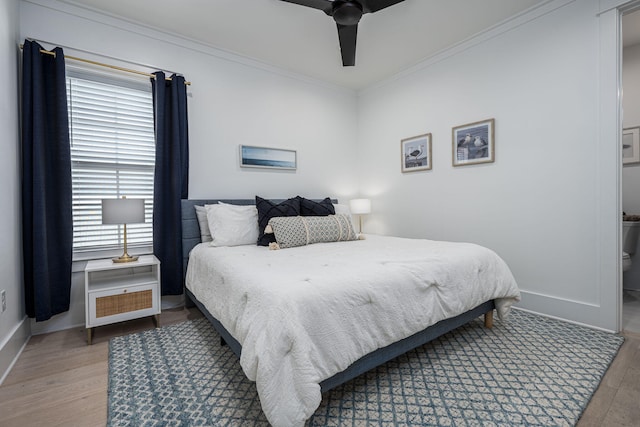 bedroom with ceiling fan, wood-type flooring, and ornamental molding