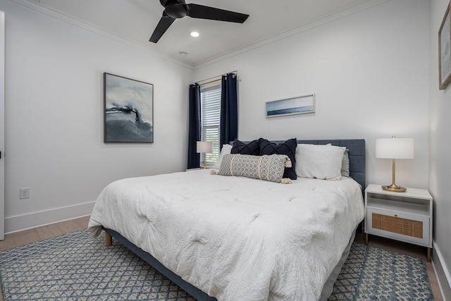 bedroom featuring crown molding, wood-type flooring, and ceiling fan