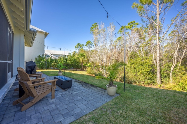 view of patio featuring a grill and an outdoor fire pit