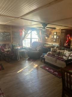 living room featuring ceiling fan and hardwood / wood-style flooring