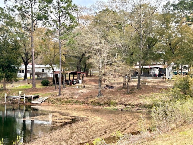 exterior space featuring a boat dock and a water view