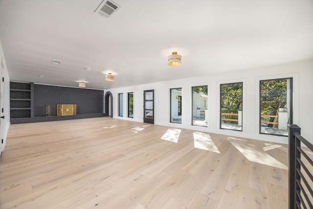 unfurnished living room with light wood finished floors and visible vents