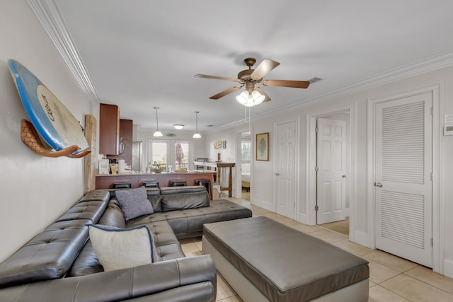 living room featuring light tile patterned floors, ornamental molding, and ceiling fan