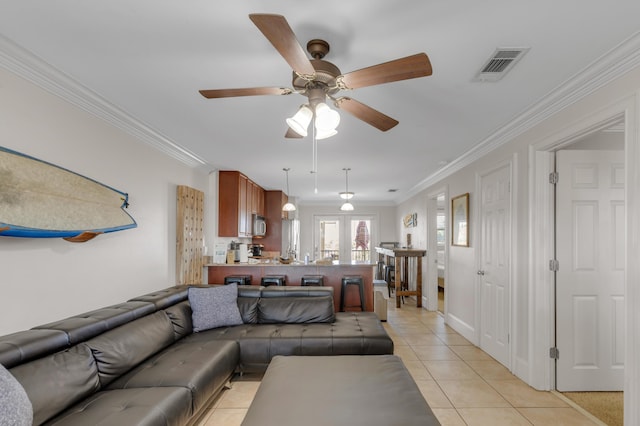 tiled living room with crown molding and ceiling fan