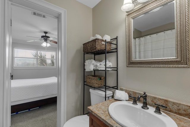 bathroom featuring ceiling fan, vanity, and toilet