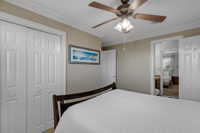 bedroom with ceiling fan, ornamental molding, ensuite bathroom, and a closet