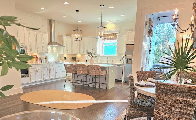 kitchen featuring white cabinetry, wall chimney exhaust hood, dark wood-type flooring, and a kitchen island