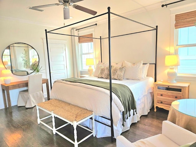 bedroom with dark hardwood / wood-style flooring, ornamental molding, and ceiling fan