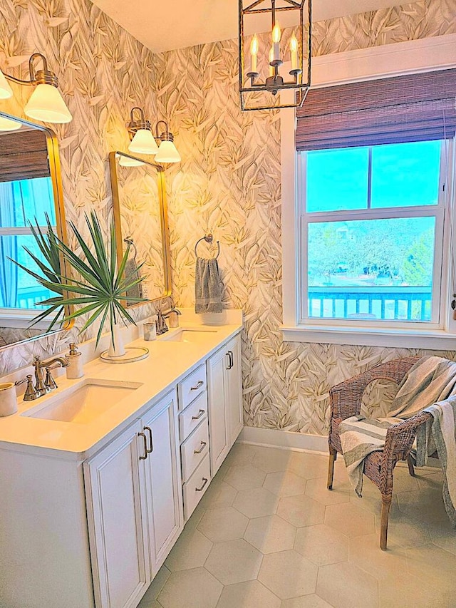 bathroom featuring plenty of natural light, a chandelier, and vanity