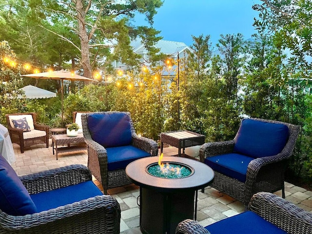 view of patio / terrace with an outdoor living space with a fire pit