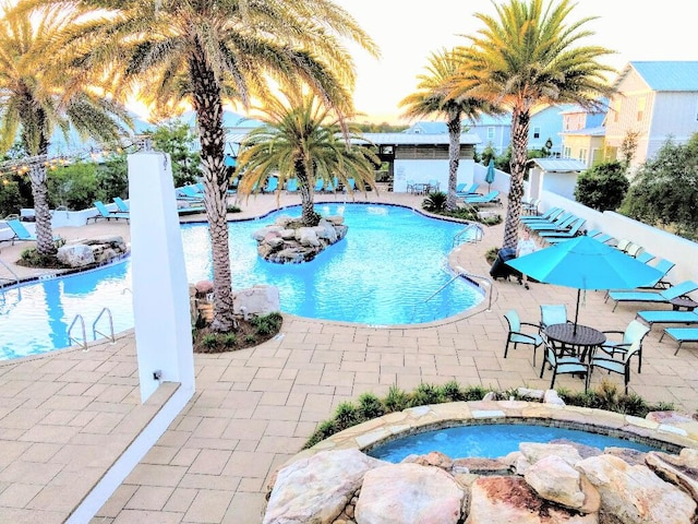 view of pool with a community hot tub and a patio area