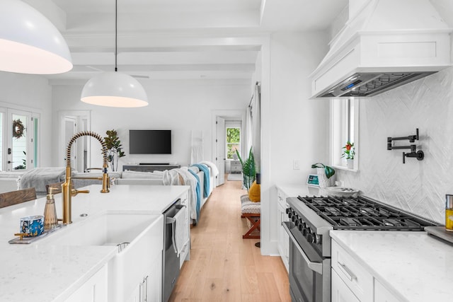 kitchen with light stone countertops, pendant lighting, stainless steel appliances, custom range hood, and white cabinets