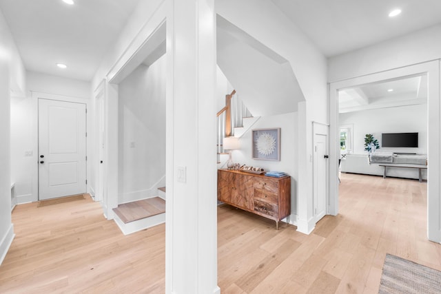 hall with beam ceiling and light hardwood / wood-style flooring