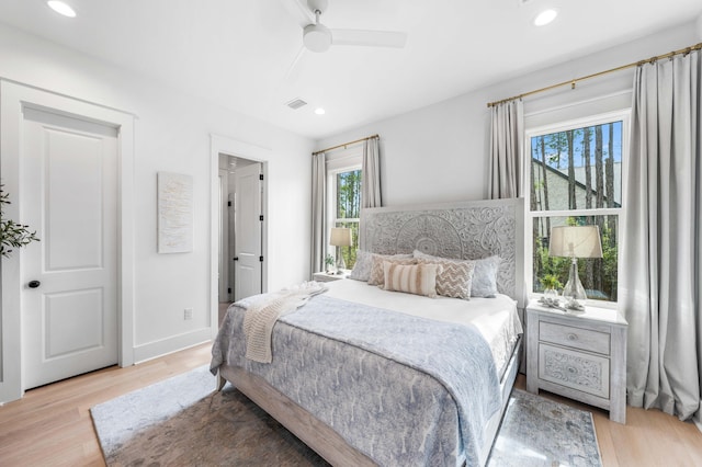 bedroom with ceiling fan and light hardwood / wood-style flooring