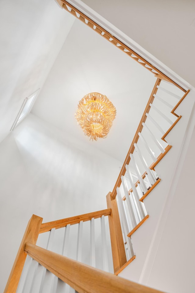 stairway featuring a chandelier