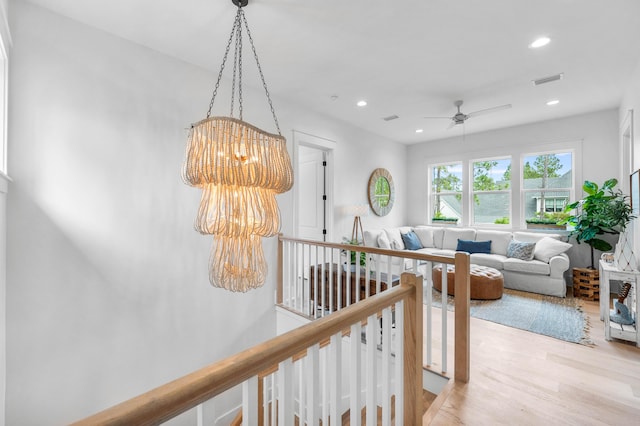 hall featuring light hardwood / wood-style flooring and a chandelier