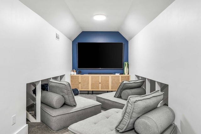 interior space with carpet flooring and vaulted ceiling