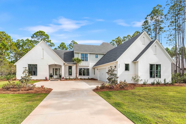 view of front of house featuring a garage and a front lawn