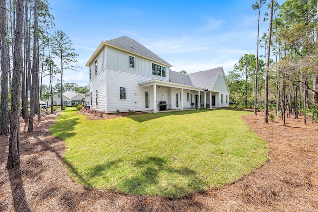 489 Hideaway Cir, Santa Rosa Beach, FL 32459 - back of property featuring roof with shingles, a lawn, and board and batten siding
