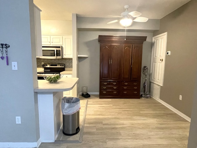 1501 N Partin Dr Unit 209, Niceville, FL 32578 - kitchen with white cabinets, ceiling fan, appliances with stainless steel finishes, tasteful backsplash, and dark brown cabinets