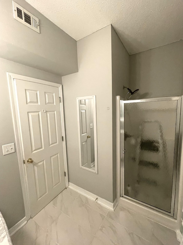 1501 N Partin Dr Unit 209, Niceville, FL 32578 - bathroom with a textured ceiling and walk in shower