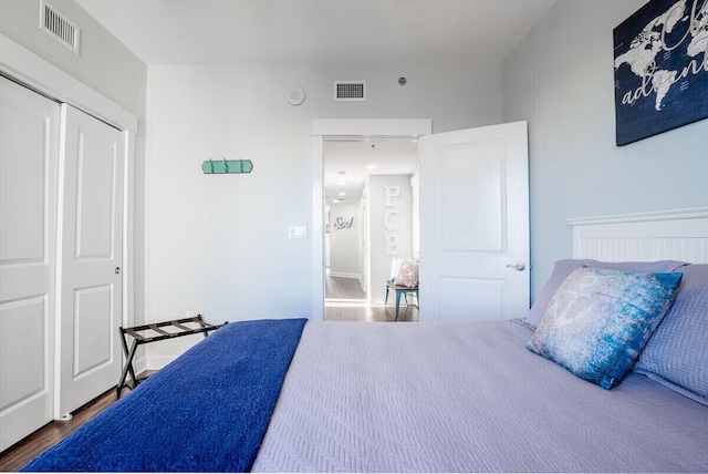 bedroom featuring wood-type flooring and a closet