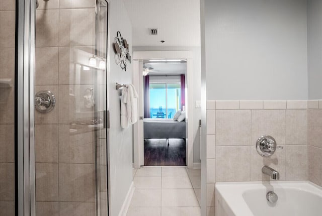 bathroom featuring tile patterned flooring and shower with separate bathtub