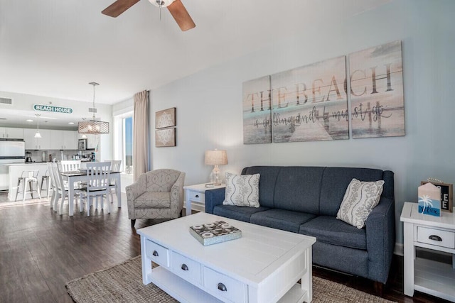 living room with ceiling fan and dark hardwood / wood-style floors