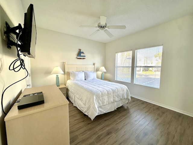 bedroom with ceiling fan and dark wood-type flooring