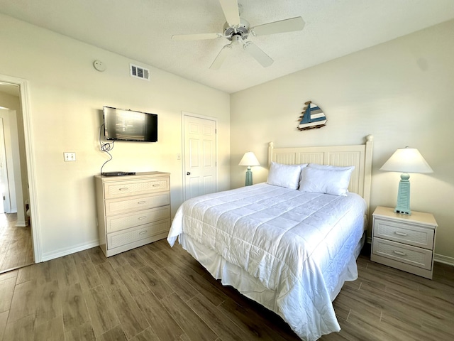 bedroom with ceiling fan and dark wood-type flooring