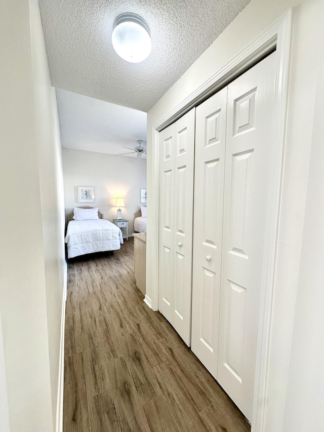 bedroom featuring a closet, a textured ceiling, and hardwood / wood-style flooring