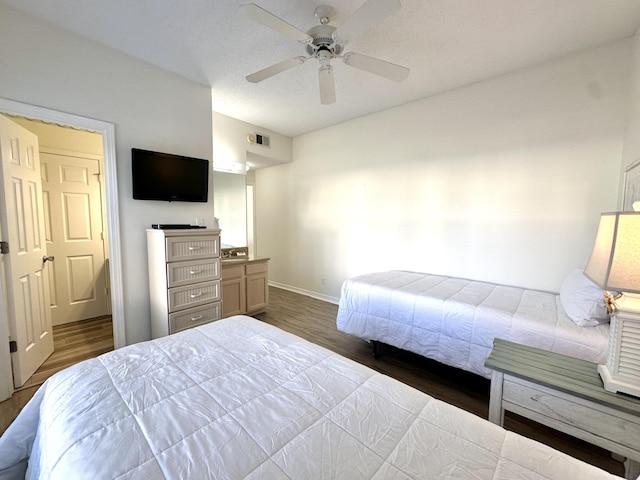 bedroom featuring ceiling fan and dark wood-type flooring