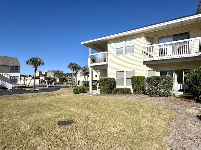 view of property exterior with a yard