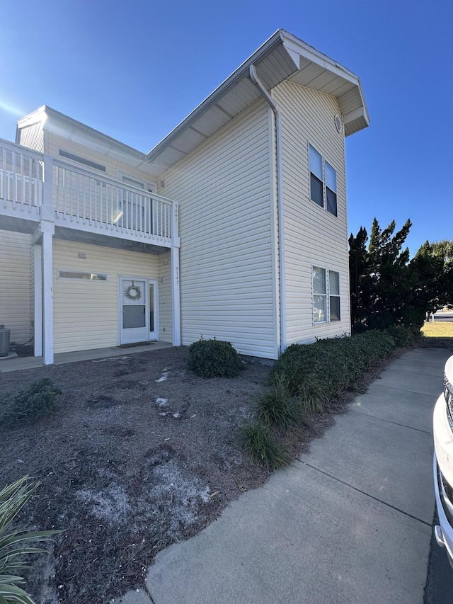 view of home's exterior featuring a balcony and cooling unit