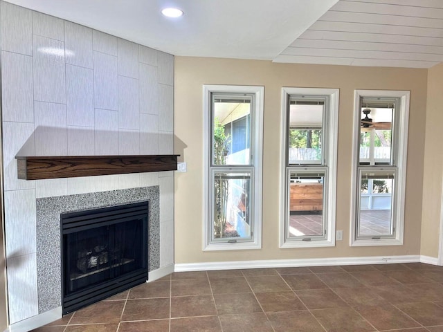 interior space featuring dark tile patterned floors and a tiled fireplace